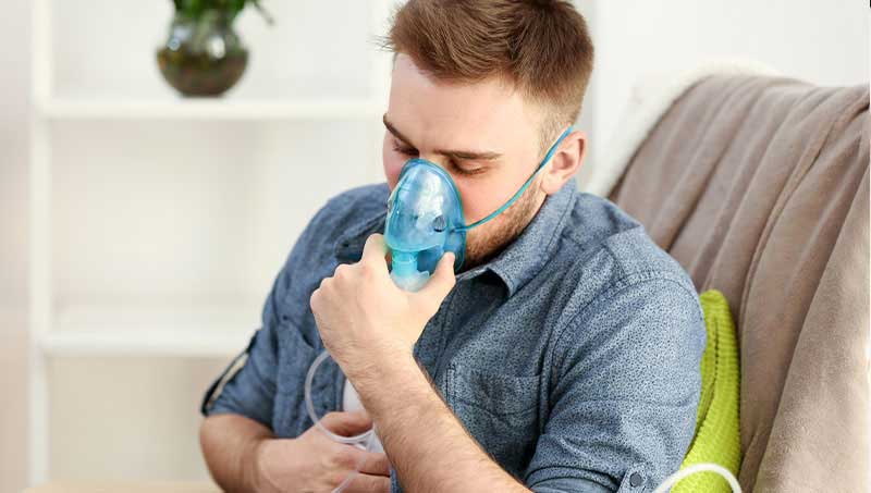 Man using nebulizer for asthma control