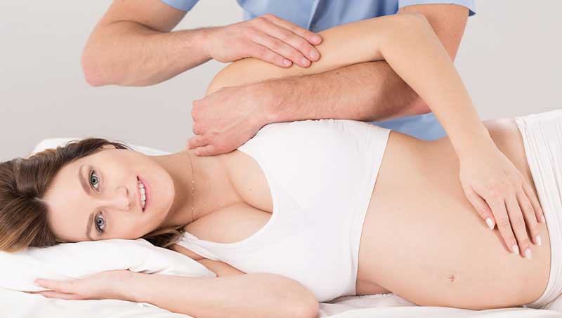 Pregnant woman getting a chiropractic adjustment