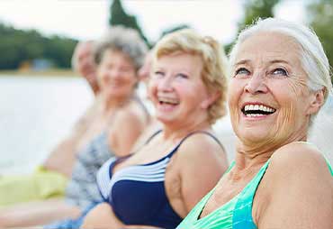 Mature women enjoying leisure sports together in the summer to stay healthy