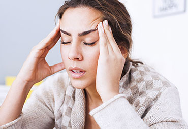 Woman suffering with a headache