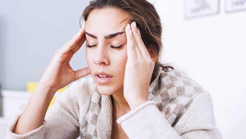 Woman suffering with severe headaches