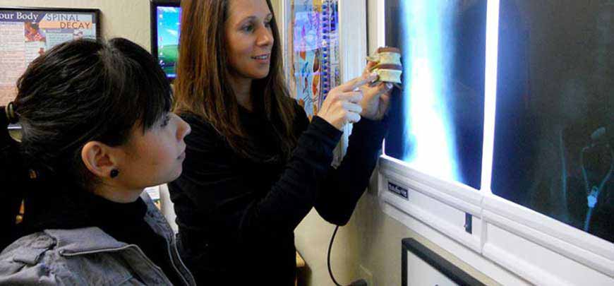 Chiropractor discussing x-ray results with patient